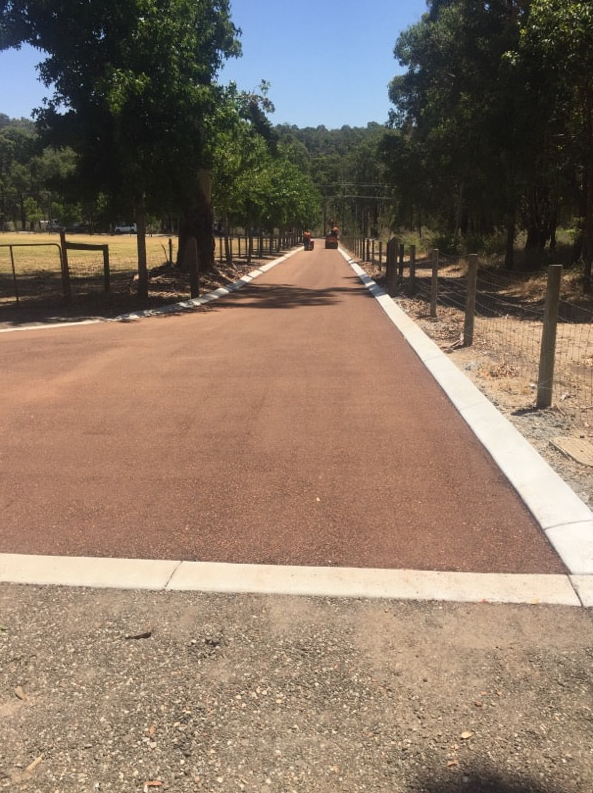 This is a photo of a hot spray & seal bitumen roadway which is in the process of being installed by Clifton Asphalt & Bitumen Surfacing